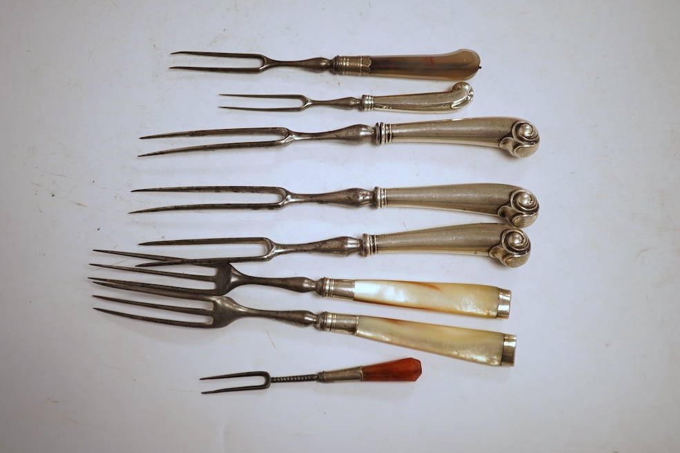 Five assorted George pistol handled steel pronged forks, four with white metal handles and one with agate handle, together with two similar mother of pearl handled steel pronged forks, largest 20.5cm and a small agate ha